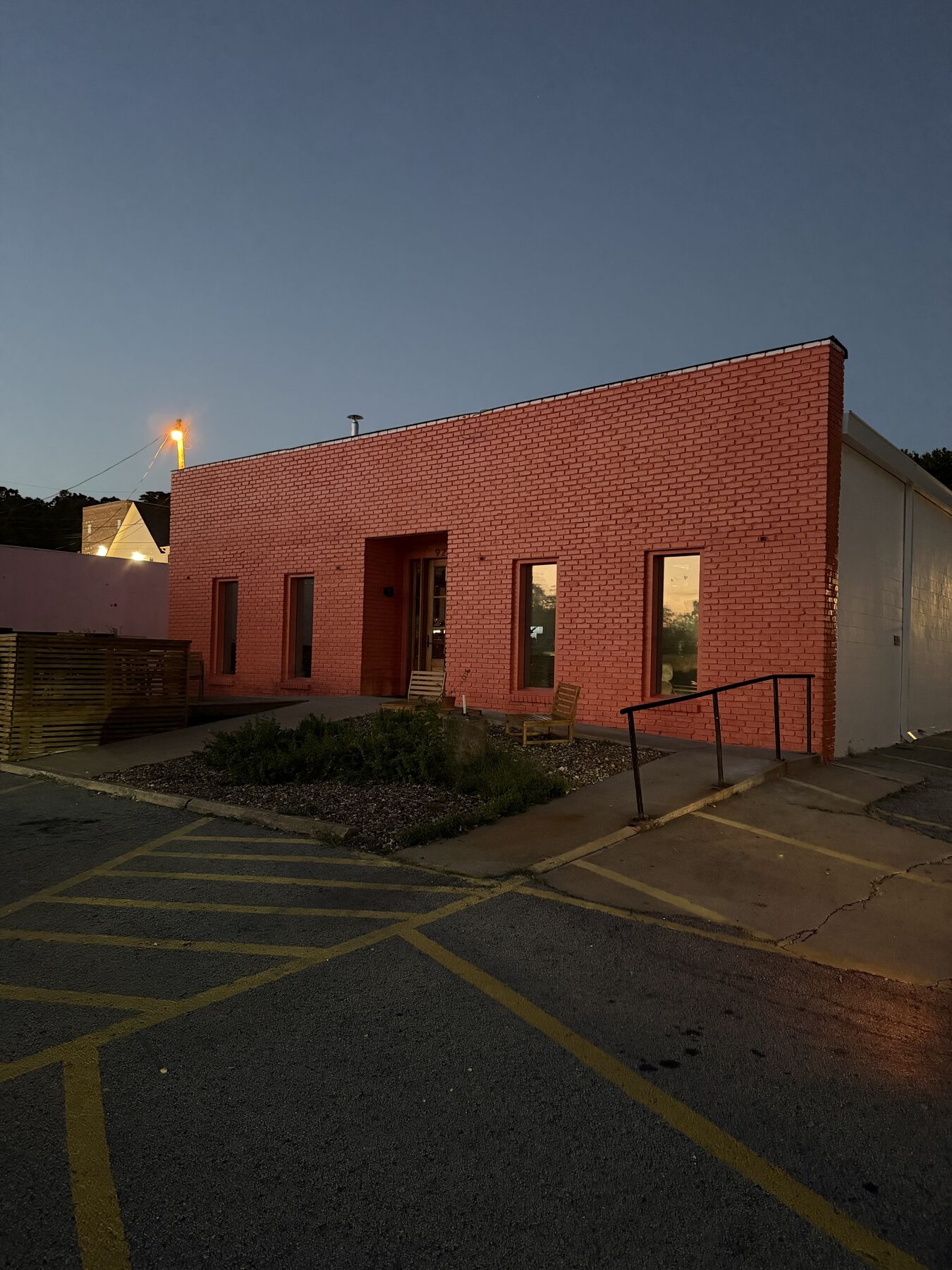 Side elevation of the Pink House Alchemy building with new coral finish