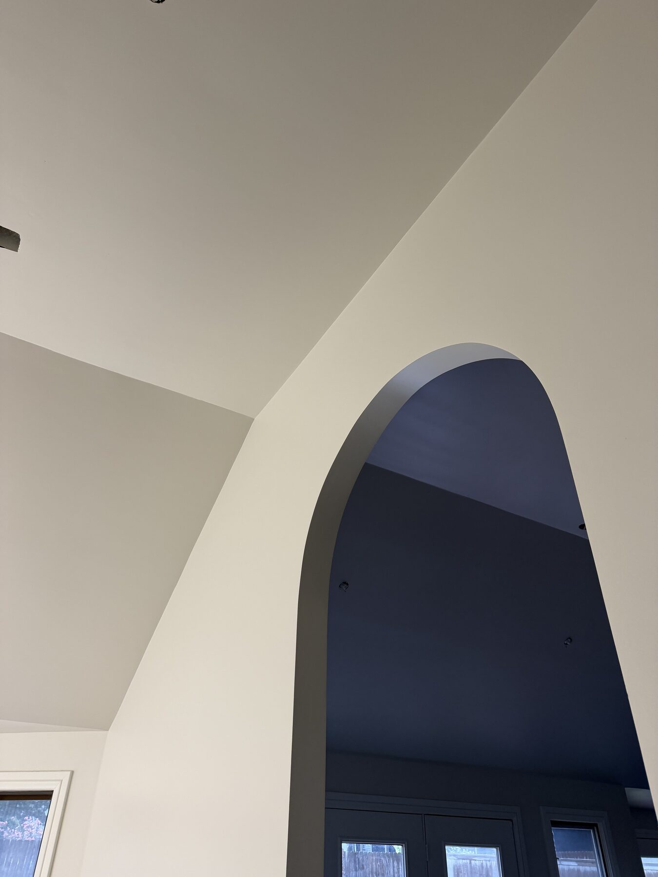 Close view of an arched interior opening with crisp paint lines