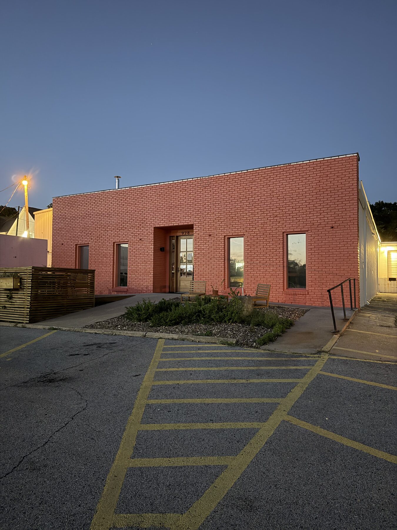 Front corner of the repainted Pink House Alchemy building at blue hour