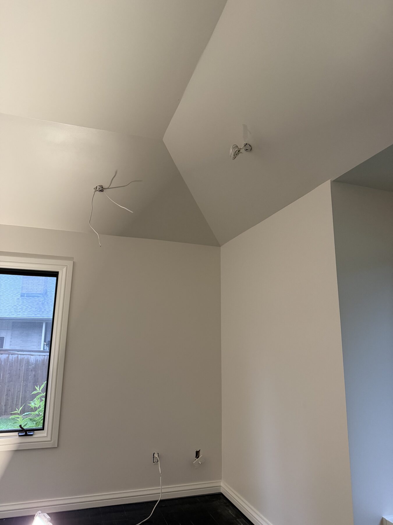 Freshly painted bedroom with vaulted ceiling and window