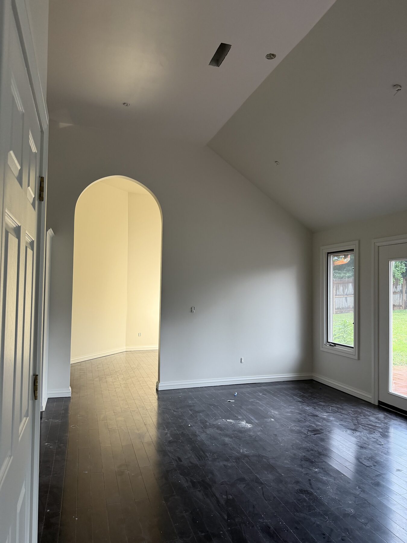 Painted interior with arched doorway and vaulted ceiling